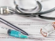 Update on Ongoing Exactech Lawsuit A stethoscope, a syringe, a vial, and a pen on top of a medical declaration form.