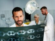 Orthopaedic Oncology: The Evolving Role of Traditional Surgical Techniques and Limb-Sparing Surgeries Doctors examine and discuss a patient's medical scans in a clinical setting.