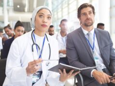 Join the 41st Annual Shoulder Course: Elevate Your Expertise in Shoulder Surgery A diverse group of professionals, including a female doctor and a businessman, attentively attending a seminar.