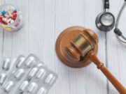 Arkansas Sues Optum, Express Scripts, and Others Over Opioid Epidemic: Implications for Orthopaedic Professionals A wooden gavel, a stethoscope, and various medications symbolize the intersection of law, healthcare, and the opioid crisis.