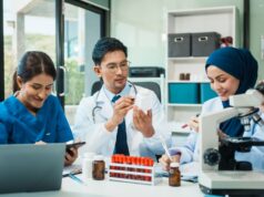 Maintaining Ethical Standards in Orthopaedic Clinical Trials A diverse group of healthcare professionals collaborates in a laboratory, analyzing medical samples and data.