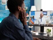 From Clinic to Screen: The Future of Telemedicine in Orthopaedic Practice A person is having a virtual consultation with a doctor via a video call on a computer screen.