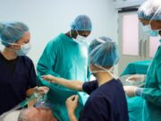 The Fellowship Gap: Are We Failing the Next Generation of Orthopaedic Surgeons? surgical team working on patient in hospital operating room