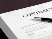 Noncompetes and Contract Clauses: What’s Changing in Orthopaedic Employment Agreements? Contract on desktop