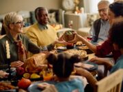 Thankful for Mobility: Helping Patients Stay Active Through the Holidays happy woman passing food to her family