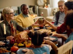 Thankful for Mobility: Helping Patients Stay Active Through the Holidays happy woman passing food to her family