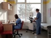Cold Weather Joint Stiffness and Its Impact on Surgical Timing Doctors in hospital room with snow outside the window
