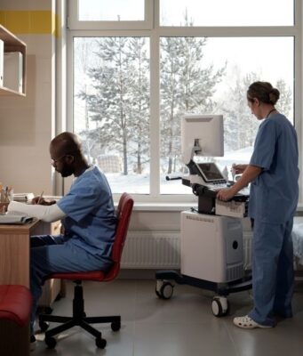 Cold Weather Joint Stiffness and Its Impact on Surgical Timing Doctors in hospital room with snow outside the window